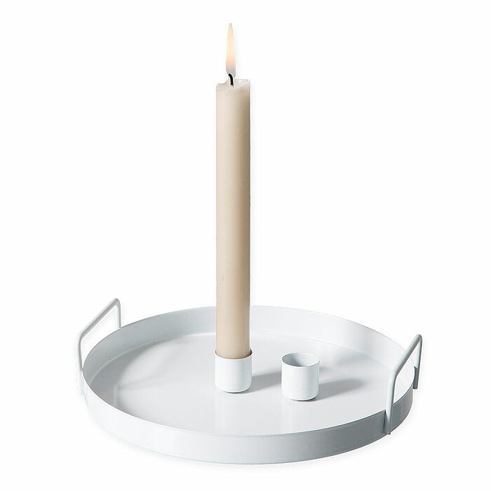 Eine beige Halbach Stabkerze brennt auf einem weißen Metalltablett mit Griffen. Das Tablett hat einen weißen Kerzenhalter und einen weiteren, unbenutzten Halter. Die Produkte stammen vom Hersteller "Halbach".